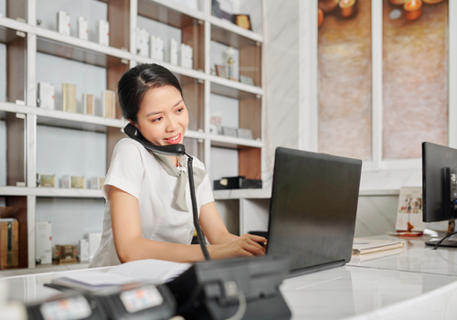 Front desk receptionist helping patients at a practice