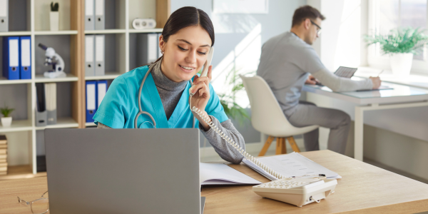 Front desk staff member on the phone at a practice